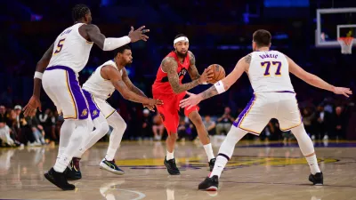 Jan 18, 2026; Los Angeles, California, USA; Toronto Raptors forward Brandon Ingram (3) moves the ball against Los Angeles Lakers center Deandre Ayton (5) guard Marcus Smart (36) and guard Luka Doncic (77) during the second half at Crypto.com Arena. Mandatory Credit: Gary A. Vasquez-Imagn Images