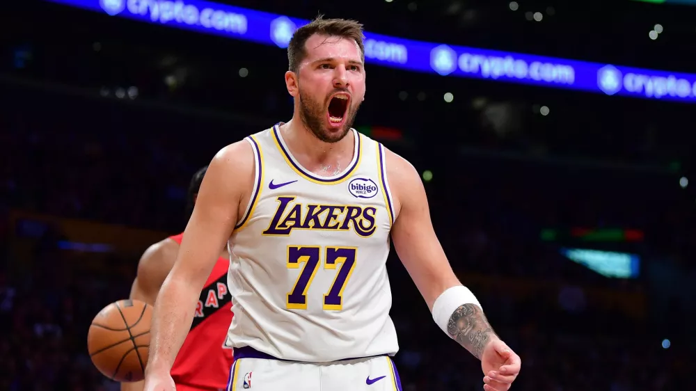 Jan 18, 2026; Los Angeles, California, USA; Los Angeles Lakers guard Luka Doncic (77) reacts during the first half at Crypto.com Arena. Mandatory Credit: Gary A. Vasquez-Imagn Images