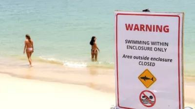 A warning sign is in place for swimmers following the recent shark attack at Sydney Harbour, Australia, January 19, 2026. REUTERS/Jeremy Piper