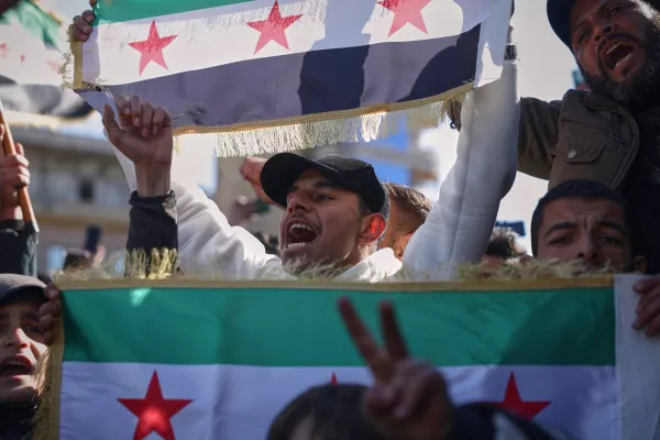 Government supporters celebrate a day after Syrian government troops took control of Raqqa from the Syrian Democratic Forces (SDF), at Al-Naeem roundabout in the city center of Raqqa, northeastern Syria, Monday, Jan. 19, 2026. (AP Photo/Ghaith Alsayed)