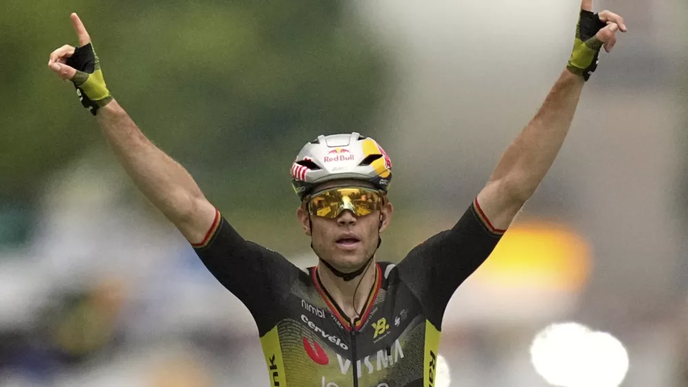 Belgium's Wout van Aert crosses the finish line to win the twenty-first stage of the Tour de France cycling race over 132.3 kilometers (82.1 miles) with start in Mantes-la-Ville and finish on the Champs-Elysees in Paris, France, Sunday, July 27, 2025. (AP Photo/Thibault Camus)