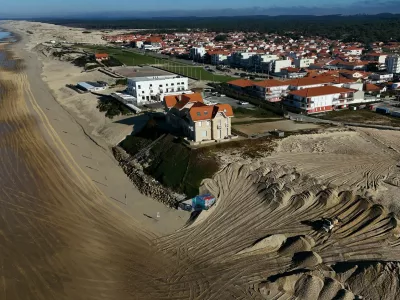 This aerial picture shows a mechanical excavator using sand brought by trucks from the northern dune cord outside the city, to reinforce the dune beside twin early 20th century villas (C) and a hotel, threatened by marine erosion, in Biscarosse southwestern France on January 17, 2025.,Image: 955698814, License: Rights-managed, Restrictions:, Model Release: no