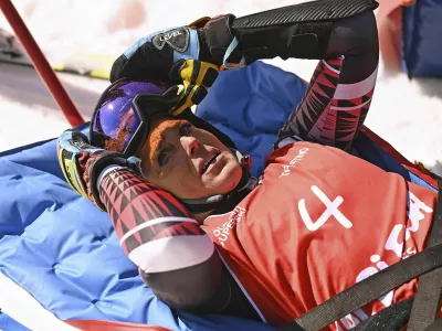Italy's Federica Brignone is carried away on a toboga after she broke multiple bones in her left leg during a giant slalom crash at the Italian championships in the Lusia ski area, in Val di Fassa, Italy, Thursday, April 3, 2025. (AP Photo/Elvis Piazzi)
