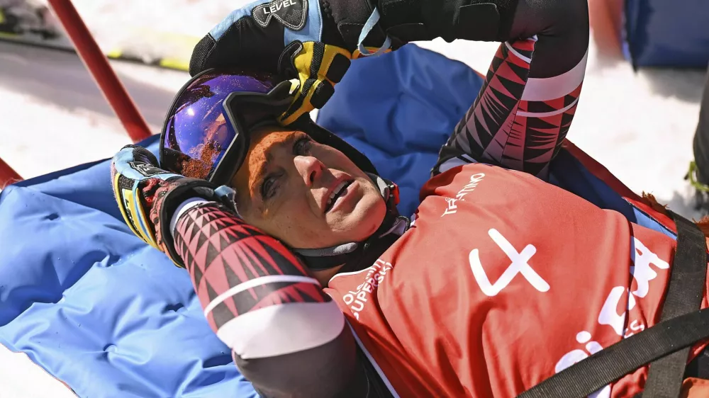 Italy's Federica Brignone is carried away on a toboga after she broke multiple bones in her left leg during a giant slalom crash at the Italian championships in the Lusia ski area, in Val di Fassa, Italy, Thursday, April 3, 2025. (AP Photo/Elvis Piazzi)