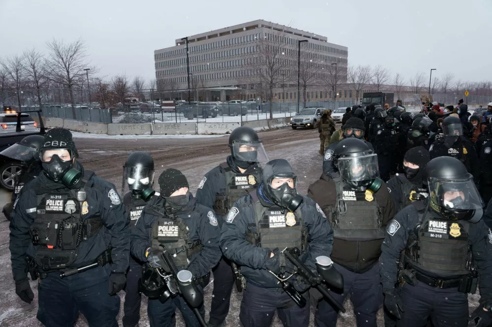  SENSITIVE MATERIAL. THIS IMAGE MAY OFFEND OR DISTURB  U.S. Customs and Border Protection (CBP) agents stand guard after pushing demonstrators out of the street during a protest outside the Bishop Henry Whipple Federal Building, more than a week after a U.S. Immigration and Customs Enforcement (ICE) agent fatally shot Renee Nicole Good on January 7, in Minneapolis, Minnesota, U.S., January 16, 2026. REUTERS/Tim Evans