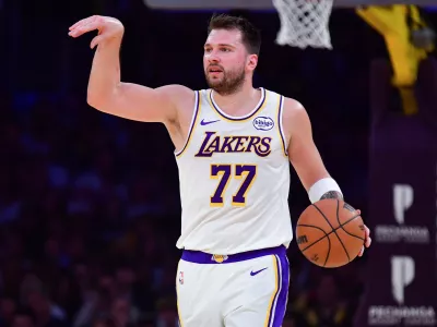 Jan 18, 2026; Los Angeles, California, USA; Los Angeles Lakers guard Luka Doncic (77) moves the ball down court against the Toronto Raptors during the first half at Crypto.com Arena. Mandatory Credit: Gary A. Vasquez-Imagn Images