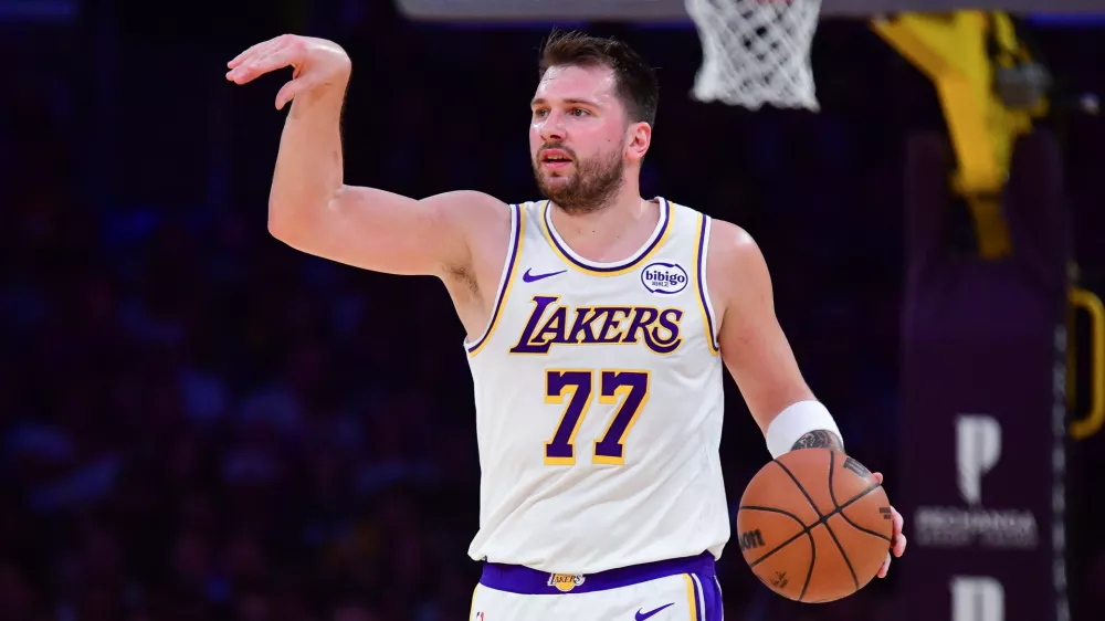 Jan 18, 2026; Los Angeles, California, USA; Los Angeles Lakers guard Luka Doncic (77) moves the ball down court against the Toronto Raptors during the first half at Crypto.com Arena. Mandatory Credit: Gary A. Vasquez-Imagn Images
