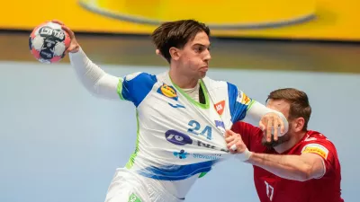 Slovenia's Andraz Makuc, left, and Switzerland's Samuel Röthlisberger challenge during the European Championship handball match between Switzerland and Slovenia, in Baerum, Norway, Sunday Jan. 18, 2026. (Cornelius Poppe/NTB via AP)