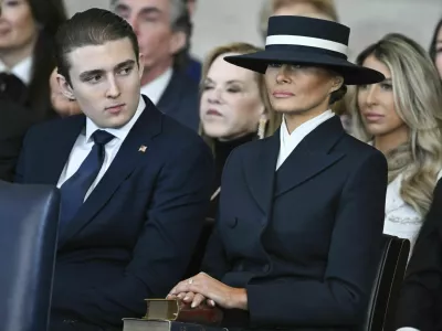 Barron Trump and first lady Melania Trump listen as President Donald Trump delivers remarks after being sworn in during the 60th Presidential Inauguration in the Rotunda of the U.S. Capitol in Washington, Monday, Jan. 20, 2025. (Saul Loeb/Pool photo via AP)