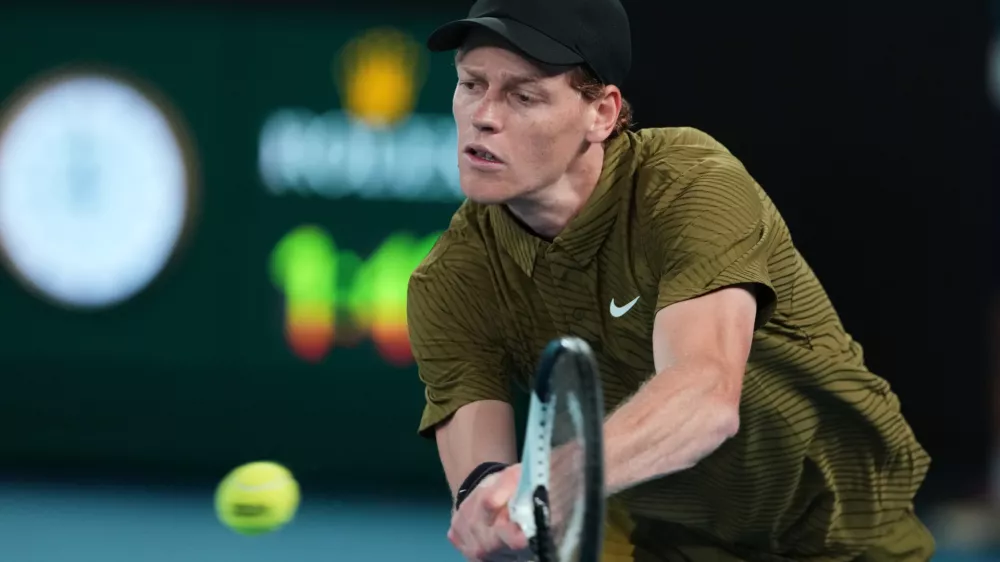 Jannik Sinner of Italy plays a backhand return to James Duckworth of Australia during their second round match at the Australian Open tennis championship in Melbourne, Australia, Thursday, Jan. 22, 2026. (AP Photo/Aaron Favila)