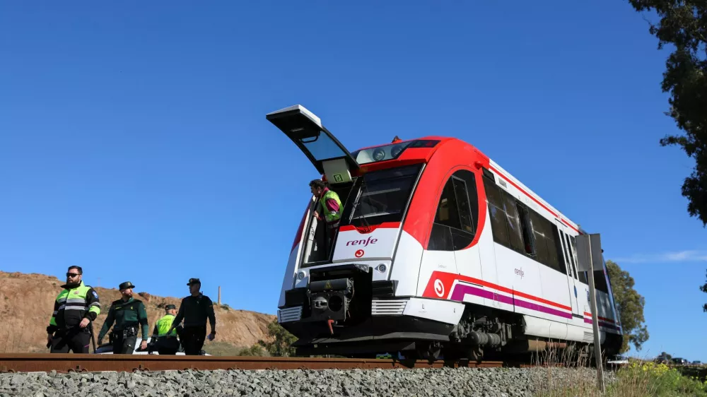 Members of the Spanish police force work at the site where a commuter train collided with a crane in the country's fourth rail crash in less than a week, with several people suffering minor injuries in the crash, near the port city of Cartagena in Murcia region,Spain, January 22, 2026. REUTERS/Loyola Perez de Villegas Muniz