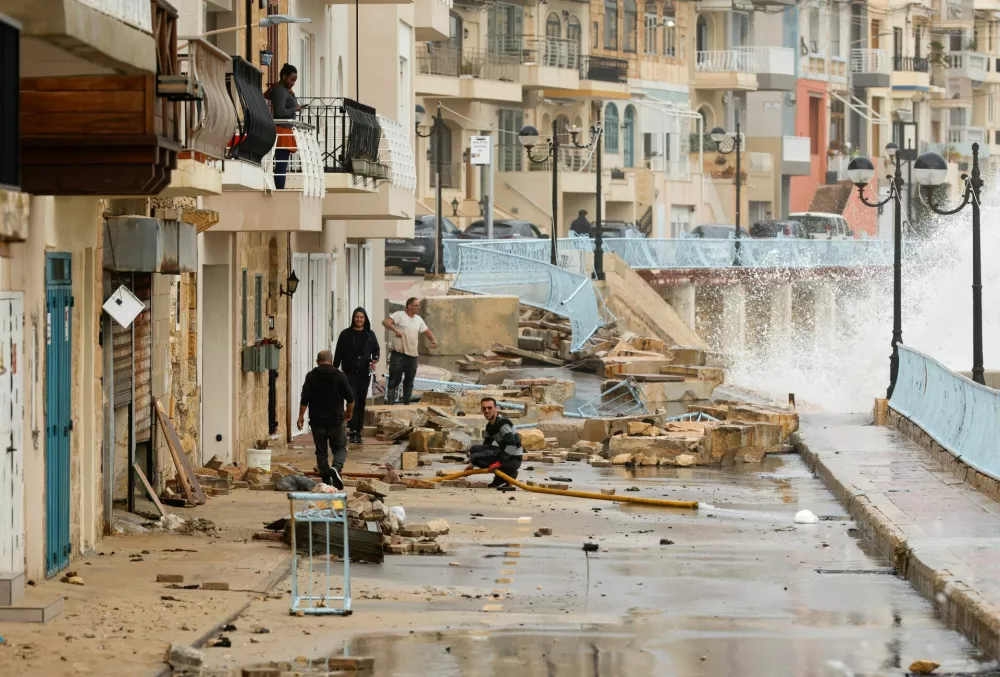 People prepare to pump water out of a property which was damaged after the area was badly hit by Storm Harry, in Marsascala, Malta, January 21, 2026. REUTERS/Darrin Zammit Lupi