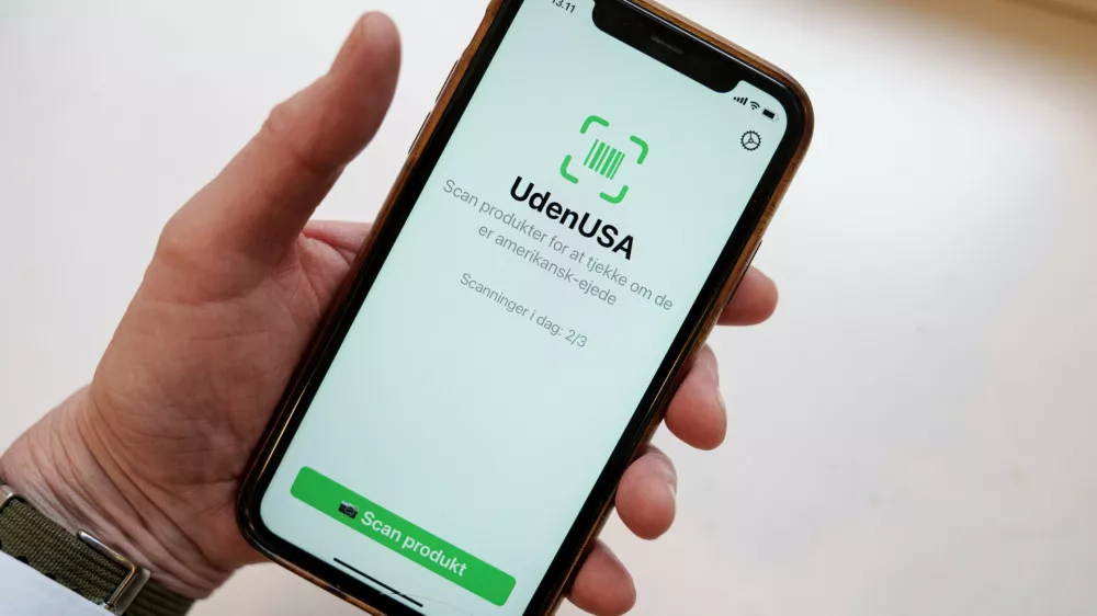 Close up on a cell phone with the app called "UdenUSA", which translates to withoutUSA in Danish and can filter out American products in supermarkets, in Copenhagen, Wednesday Jan. 21, 2026. (Liselotte Sabroe/Ritzau Scanpix via AP)