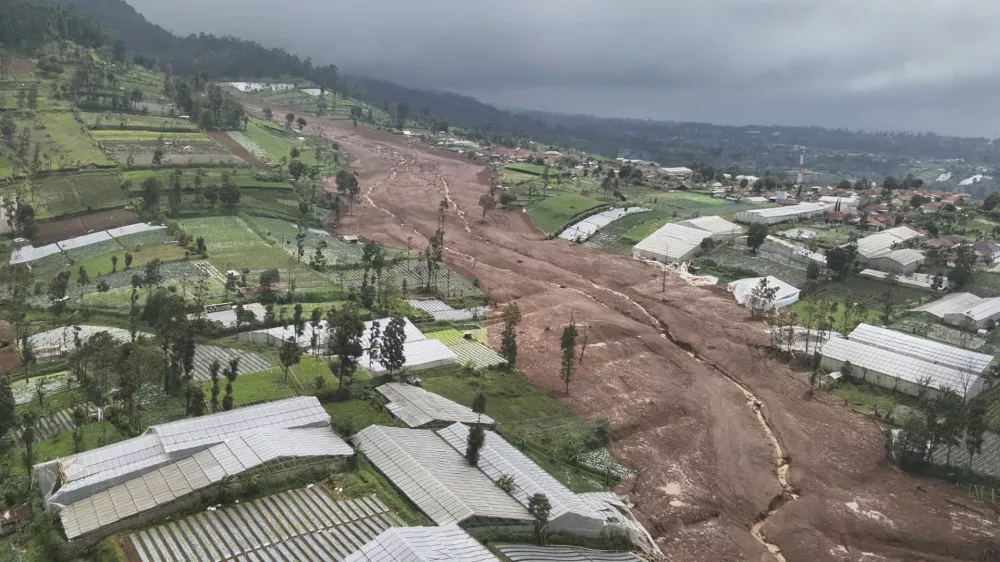 In this photo released by the Indonesian National Search and Rescue Agency (BASARNAS), an aerial shot taken using a drone shows an area affected by landslides in Pasir Langu village, in West Bandung district of West Java province, Indonesia, Saturday, Jan. 24, 2026. (BASARNAS via AP)