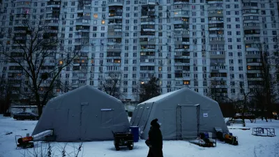A person walks past a Point of Invincibility centre, a government‑run shelter that provides basic services and heat during blackouts, set up next to an apartment building left without heating and facing long power cuts after critical civil infrastructure was hit by recent Russian missile and drone strikes, amid Russia's attack on Ukraine, in Kyiv, Ukraine, January 23, 2026. REUTERS/Alina Smutko