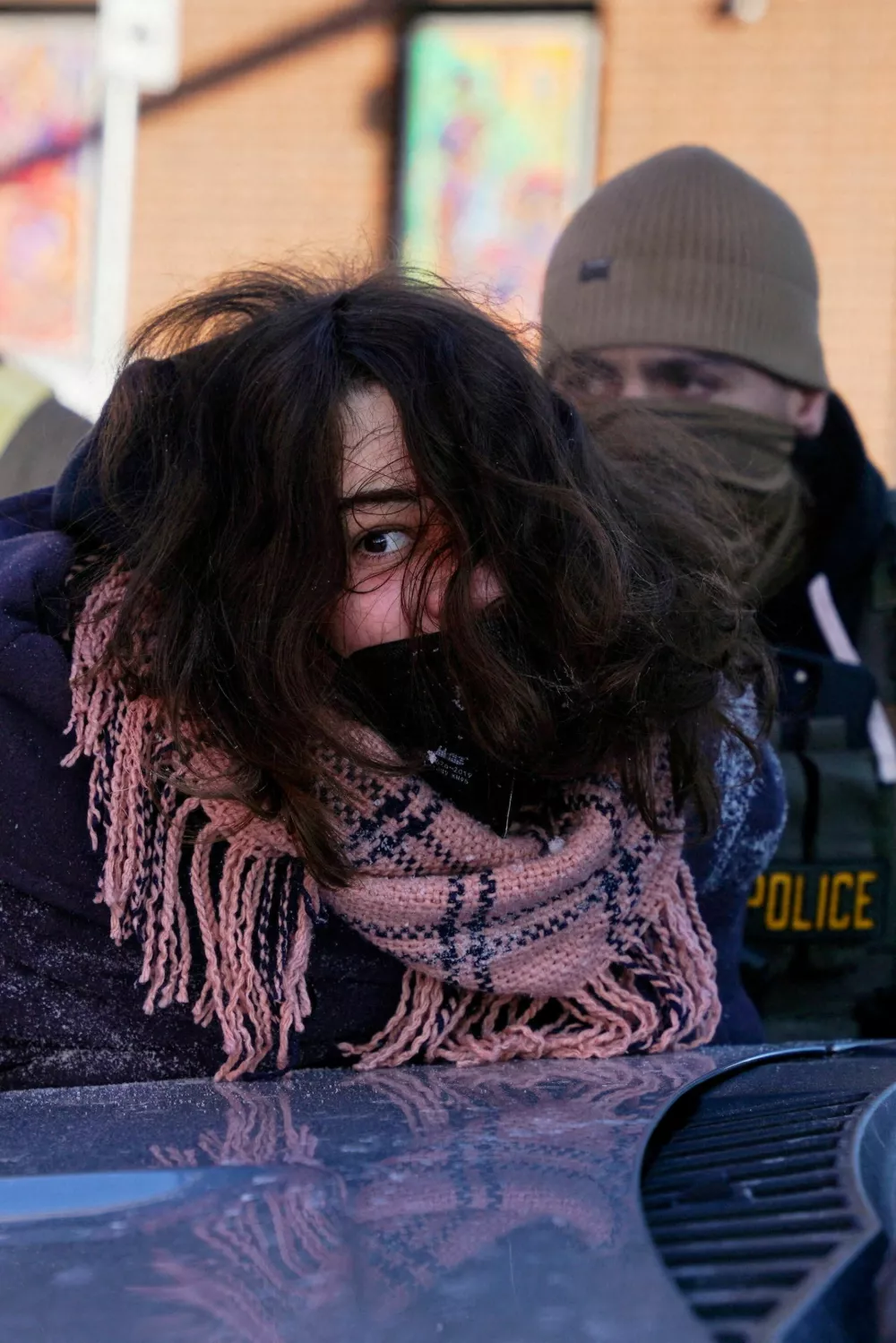A person is detained at the scene of a shooting involving federal immigration agents in Minneapolis, Minnesota, U.S., January 24, 2026. REUTERS/Seth Herald    TPX IMAGES OF THE DAY