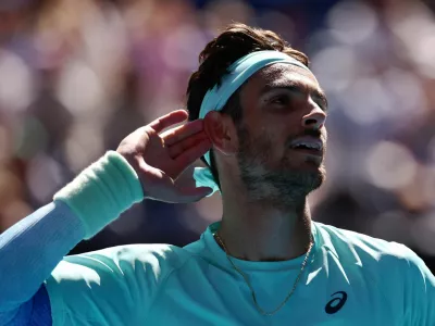 Tennis - Australian Open - Melbourne Park, Melbourne, Australia - January 26, 2026 Italy's Lorenzo Musetti reacts during his fourth round match against Taylor Fritz of the U.S. REUTERS/Tingshu Wang