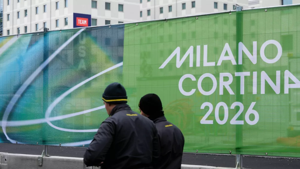 Financial guards walk outside the Olympic Village, in Milan, Italy, Thursday, Jan. 29, 2026. (AP Photo/Luca Bruno)