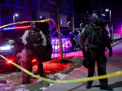 Law enforcement officers stand guard around a hotel where Greg Bovino, who has been removed from his role as the "commander at large" for the U.S. Border Patrol, is reportedly staying, in Maple Grove, Minnesota, U.S., January 26, 2026. REUTERS/Shannon Stapleton REFILE - CORRECTING LOCATION FROM "MINNEAPOLIS" TO "MAPLE GROVE".