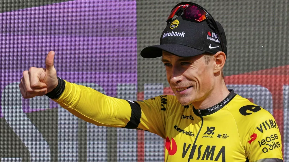 Danish rider Jonas Vingegaard, from Visma | Lease a Bike team celebrates at the podium after wining the ninth stage of La Vuelta from Alfaro to Valdezcaray, Spain, Sunday, Aug. 31, 2025. (AP Photo/Miguel Oses)