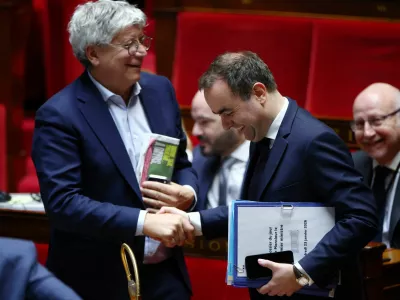 French Prime Minister Sebastien Lecornu shakes hands with Member of parliament Eric Coquerel, of La France Insoumise (LFI) and the "Nouveau Front Populaire" (New Popular Front - NFP) parliamentary group and President of the National Assembly's finance commission, after the announcement of the use by the French government of article 49.3, a special clause in the French Constitution, to push the second part of the budget bill for 2026 (PLF 2026) through the National Assembly without a vote by lawmakers, during a new debate on the draft budget bill at the National Assembly in Paris, France, January 23, 2026. REUTERS/Gonzalo Fuentes