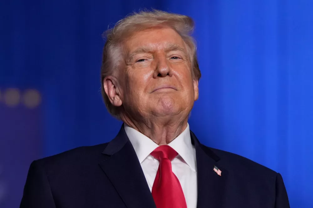 President Donald Trump stands on stage during an event at the Horizon Events Center in Clive, Iowa, Tuesday, Jan. 27, 2026. (AP Photo/Mark Schiefelbein)