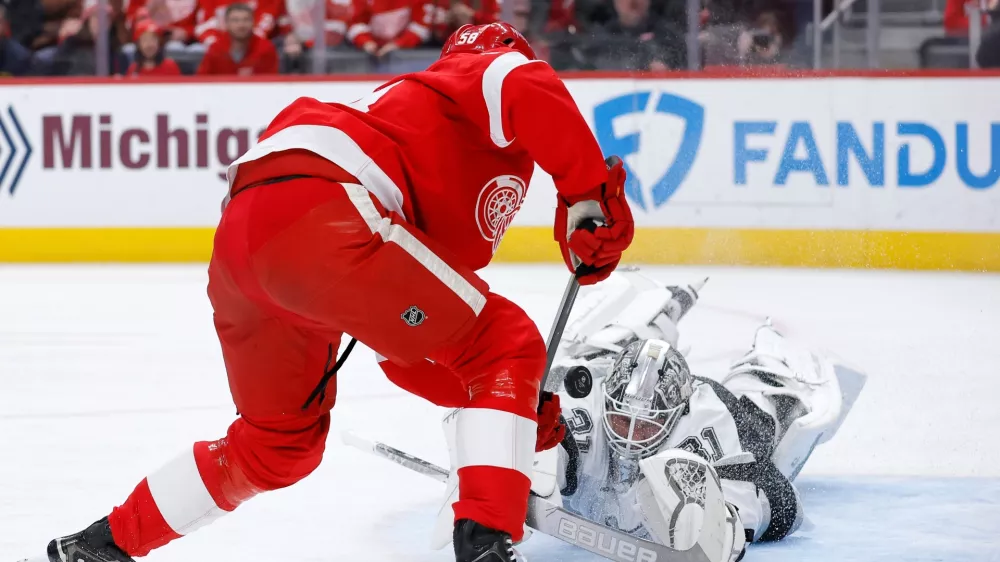 Los Angeles Kings goaltender Anton Forsberg deflects a shot on goal against Detroit Red Wings center Emmitt Finnie during the first period of an NHL hockey game, Tuesday, Jan. 27, 2026, in Detroit. (AP Photo/Duane Burleson)