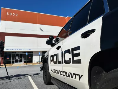 Police vehicles are seen outside the Fulton County elections hub in Union City, Ga., Wednesday, Jan. 28, 2026. (AP Photo/Emilie Megnien)