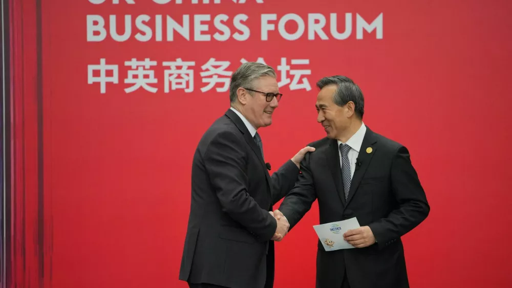Britain's Prime Minister Keir Starmer shakes hands with Ren Hongbin, Chairman of the China Council for the Promotion of International Trade (CCPIT) during the UK-China Business Forum in Beijing, China, January 30, 2026. Carl Court/Pool via REUTERS