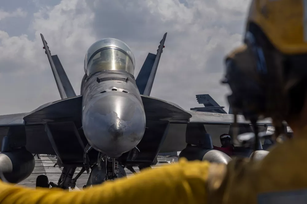 This handout photograph from the U.S. Navy shows Aviation Boatswain's Mate 2nd Class Michael Cordova directing an F/A-18F Super Hornet on the flight deck of the Nimitz-class aircraft carrier USS Abraham Lincoln in the Indian Ocean on Jan. 23, 2026. (Mass Communication Specialist Seaman Daniel Kimmelman/U.S. Navy via AP)