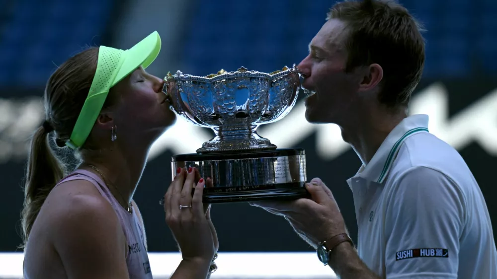 Tennis - Australian Open - Melbourne Park, Melbourne, Australia - January 30, 2026 Australia's Olivia Gadecki and Australia's John Peers pose with the trophy after winning their mixed doubles final REUTERS/Jaimi Joy