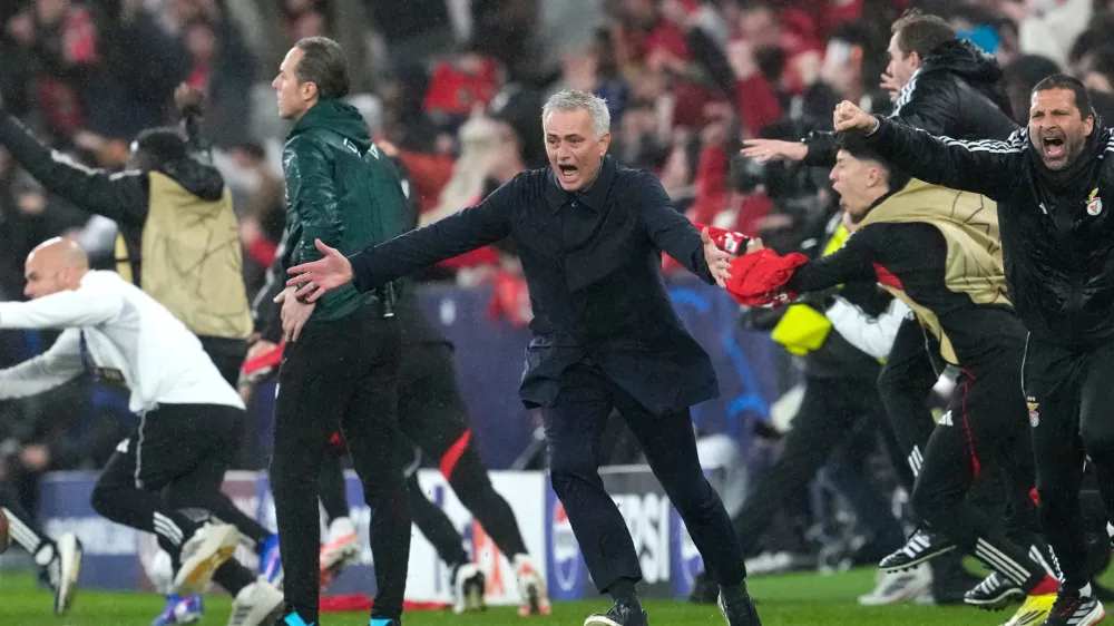 Benfica's head coach Jose Mourinho runs celebrating at the end of a Champions League opening phase soccer match between Benfica and Real Madrid, in Lisbon, Wednesday, Jan. 28, 2026. (AP Photo/Armando Franca)