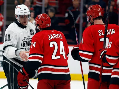 Los Angeles Kings' Anze Kopitar (11) shakes hands with Carolina Hurricanes' Seth Jarvis (24) after an NHL hockey game in Raleigh, N.C., Sunday, Feb. 1, 2026. (AP Photo/Karl DeBlaker)