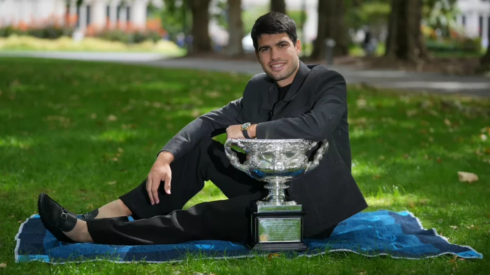 Carlos Alcaraz of Spain poses with the Norman Brookes Challenge Cup the morning after defeating Novak Djokovic of Serbia in the men's singles final at the Australian Open tennis championship, in Melbourne, Australia, Monday, Feb. 2, 2026. (AP Photo/Dita Alangkara)