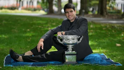 Carlos Alcaraz of Spain poses with the Norman Brookes Challenge Cup the morning after defeating Novak Djokovic of Serbia in the men's singles final at the Australian Open tennis championship, in Melbourne, Australia, Monday, Feb. 2, 2026. (AP Photo/Dita Alangkara)