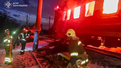 In this photo provided by the Ukrainian Emergency Service, firefighters put out the fire after Russian drones hit a passenger train in the Kharkiv region, Ukraine, Tuesday, Jan. 27, 2026. (Ukrainian Emergency Service via AP)