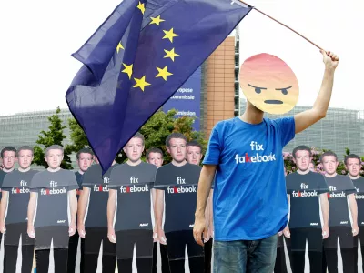 A protester holds an European Union flag next to cardboard cutouts depicting Facebook CEO Mark Zuckerberg during a demonstration ahead of a meeting between Zuckerberg and leaders of the European Parliament in Brussels, Belgium May 22, 2018. REUTERS/Francois Lenoir