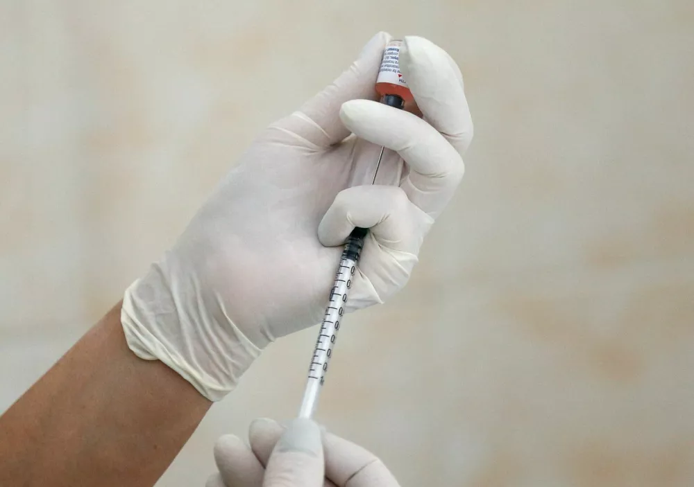 FILE PHOTO: A nurse fills a syringe with a vaccine before administering an injection at a children's clinic in Kiev, Ukraine August 14, 2019. Picture taken August 14, 2019. REUTERS/Valentyn Ogirenko/File Photo