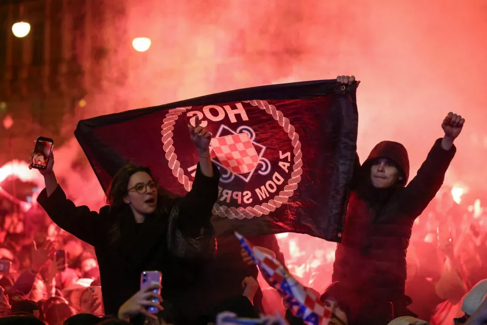 People hold a flag of the Croatian Defence Forces (HOS) during an event to celebrate Croatia's third place at the EHF 2026 Men's Handball Championship, in Zagreb, Croatia, February 2, 2026. REUTERS/Antonio Bronic
