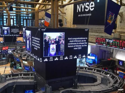 Video screens above trading posts the floor of the New York Stock Exchange display a congratulatory message to Disney parks chief Josh D'Amaro named as its next CEO, succeeding Bob Iger, Tuesday, Feb. 3, 2026. (AP Photo/Richard Drew)