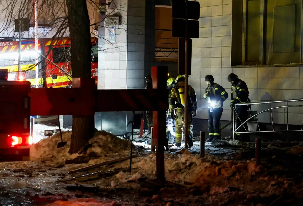 Firefighters work outside an apartment building after it was struck by a drone during Russian missile and drone attacks, in Kyiv, Ukraine, February 3, 2026. REUTERS/Thomas Peter
