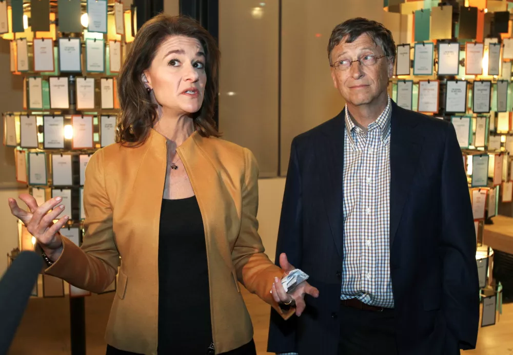 FILE PHOTO: Microsoft co-founder Bill Gates listens while his wife Melinda Gates speaks to the media at an advance tour of the newly constructed $15 million visitor center of the Bill and Melinda Gates Foundation $500 million campus in Seattle, Washington February 1, 2012. The 900,000 square foot construction, which occupies more than 12 acres in downtown Seattle, is scheduled to open to the public on February 4, 2012. REUTERS/Anthony Bolante/File Photo