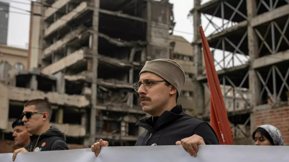 People attend a protest in front of a former army headquarters over a new law to speed its conversion into a luxury compound leased to an investment company founded by U.S. President Donald Trump's son-in-law, Jared Kushner, in Belgrade, Serbia, November 11, 2025. REUTERS/Marko Djurica