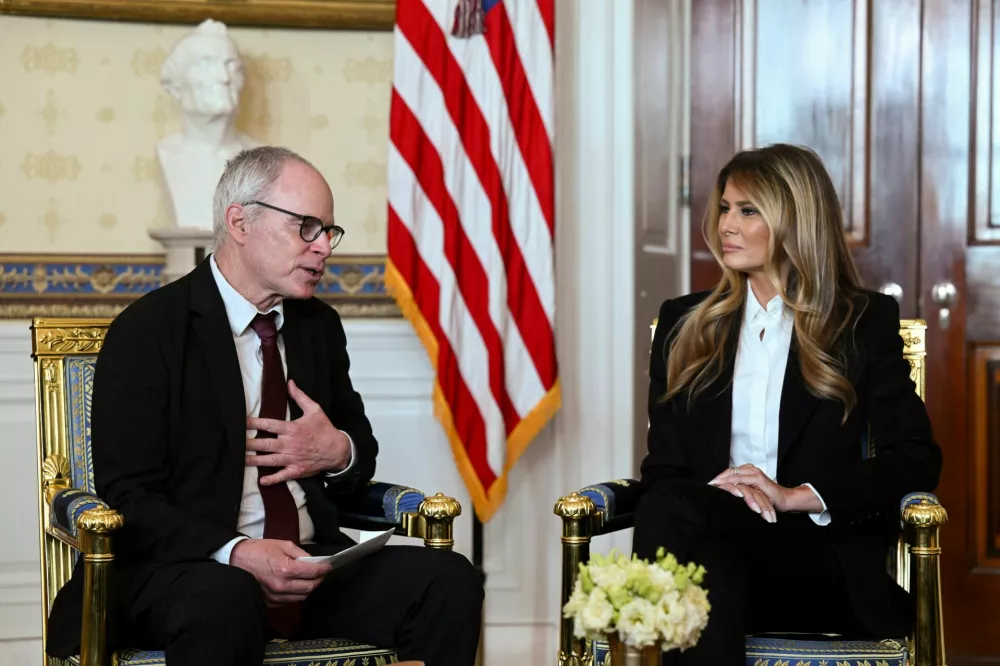 U.S. first lady Melania Trump listens as freed American-Israeli Keith Siegel, who was abducted along with his partner Aviva by Hamas on October 7, 2023, speaks at the White House in Washington, D.C., U.S., February 4, 2026. REUTERS/Annabelle Gordon