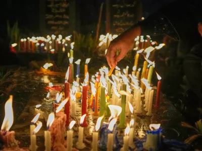 Kashmiri Shiite Muslims light candles on the graves of their relatives while offering prayers for the salvation of departed souls during Shab-e-Barat on the outskirts of Srinagar, in Indian controlled Kashmir, Tuesday, Feb. 3, 2026. (AP Photo/Mukhtar Khan)