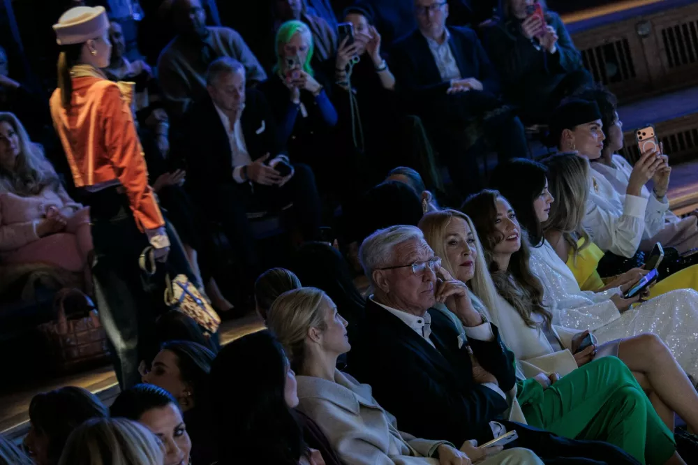 30 January 2026, Berlin: A model walks the catwalk during the Marc Cain Fashion Show at Funkhaus Berlin. Helmut Schlotterer (M), Managing Director of Marc Cain, and Jerry Hall (4r), and daughter Lizzy Jagger (Elizabeth Scarlett Jagger, 3r) sit in the front row. Photo: Carsten Koall/dpa,Image: 1070660157, License: Rights-managed, Restrictions: GERMANY OUT, Model Release: no