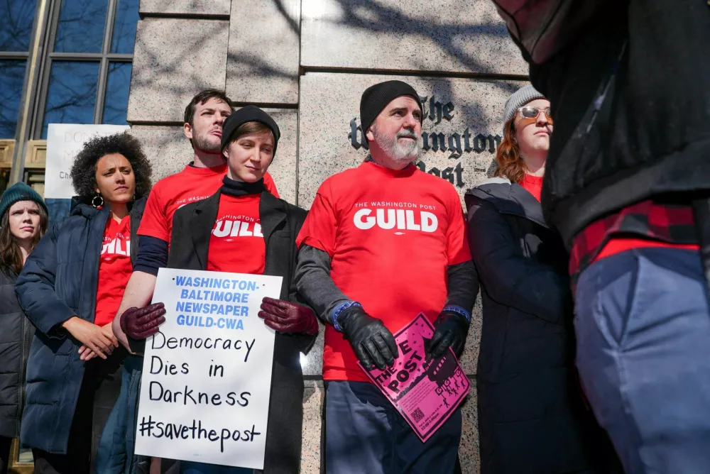 FILE PHOTO: Union members and supporters gather at a 'Save the Post' rally outside The Washington Post after widespread layoffs were announced, in Washington, D.C., U.S., February 5, 2026. REUTERS/Ken Cedeno/File Photo