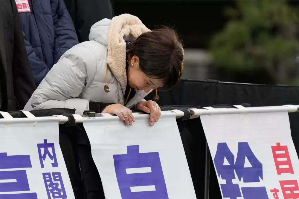 Sanae Takaichi, Japan's prime minister and president of the ruling Liberal Democratic Party, bows to supporters on the eve of the lower house election during a campaign event in Tokyo, Saturday, Feb. 7, 2026. (AP Photo/Eugene Hoshiko)
