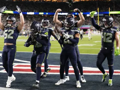 Feb 8, 2026; Santa Clara, CA, USA; Seattle Seahawks safety Julian Love (20) celebrates with teammates after intercepting the ball against the New England Patriots during the fourth quarter in Super Bowl LX at Levi's Stadium. Mandatory Credit: Kyle Terada-Imagn Images