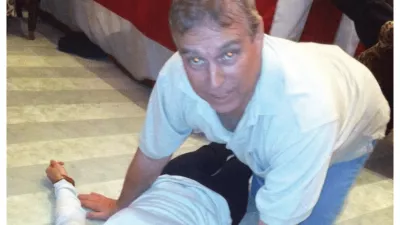 EDS NOTE: GRAPHIC CONTENT - This undated photo, released and redacted by the U.S. Department of Justice as part of the Jeffrey Epstein files, shows Andrew Mountbatten-Windsor, formerly known as Prince Andrew, leaning over an unidentified person. (U.S. Department of Justice via AP)